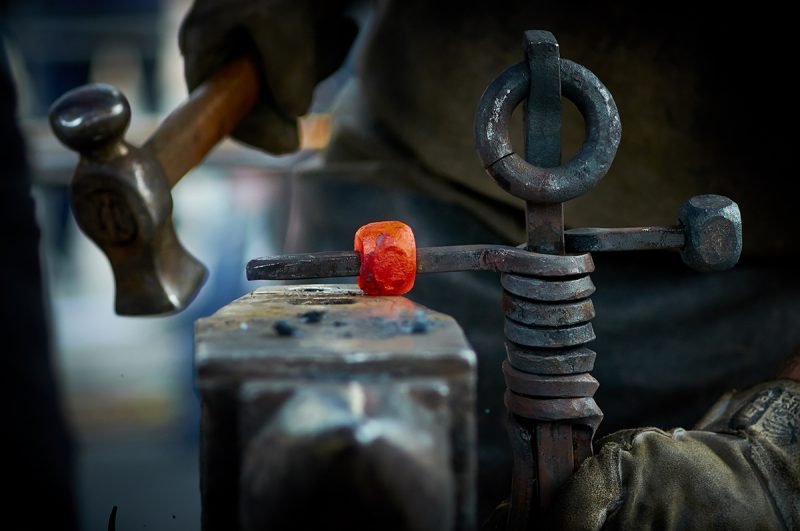 Image of a man working in iron factory